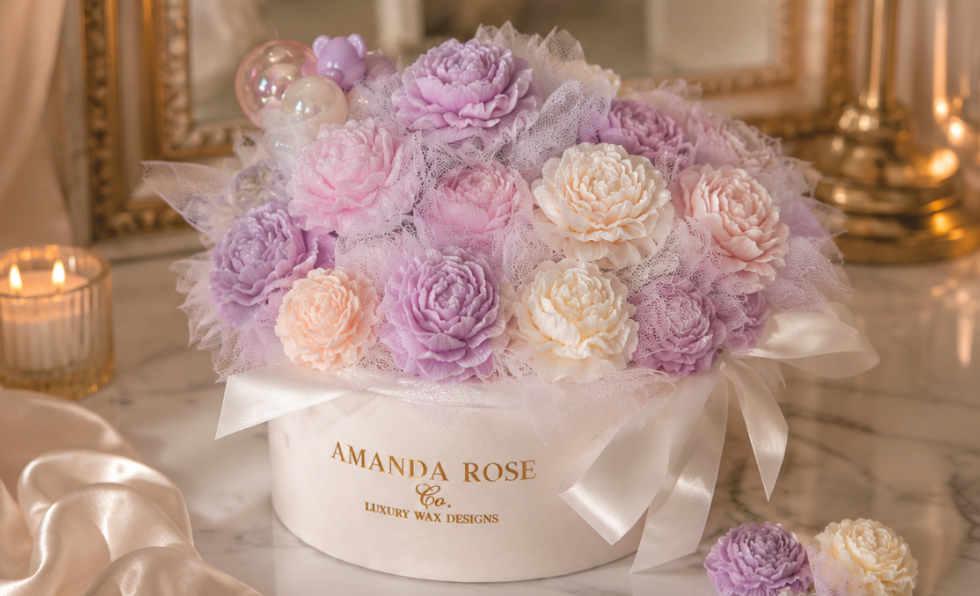 Floral arrangement in a box with 'Amanda Rose' branding on a marble surface.