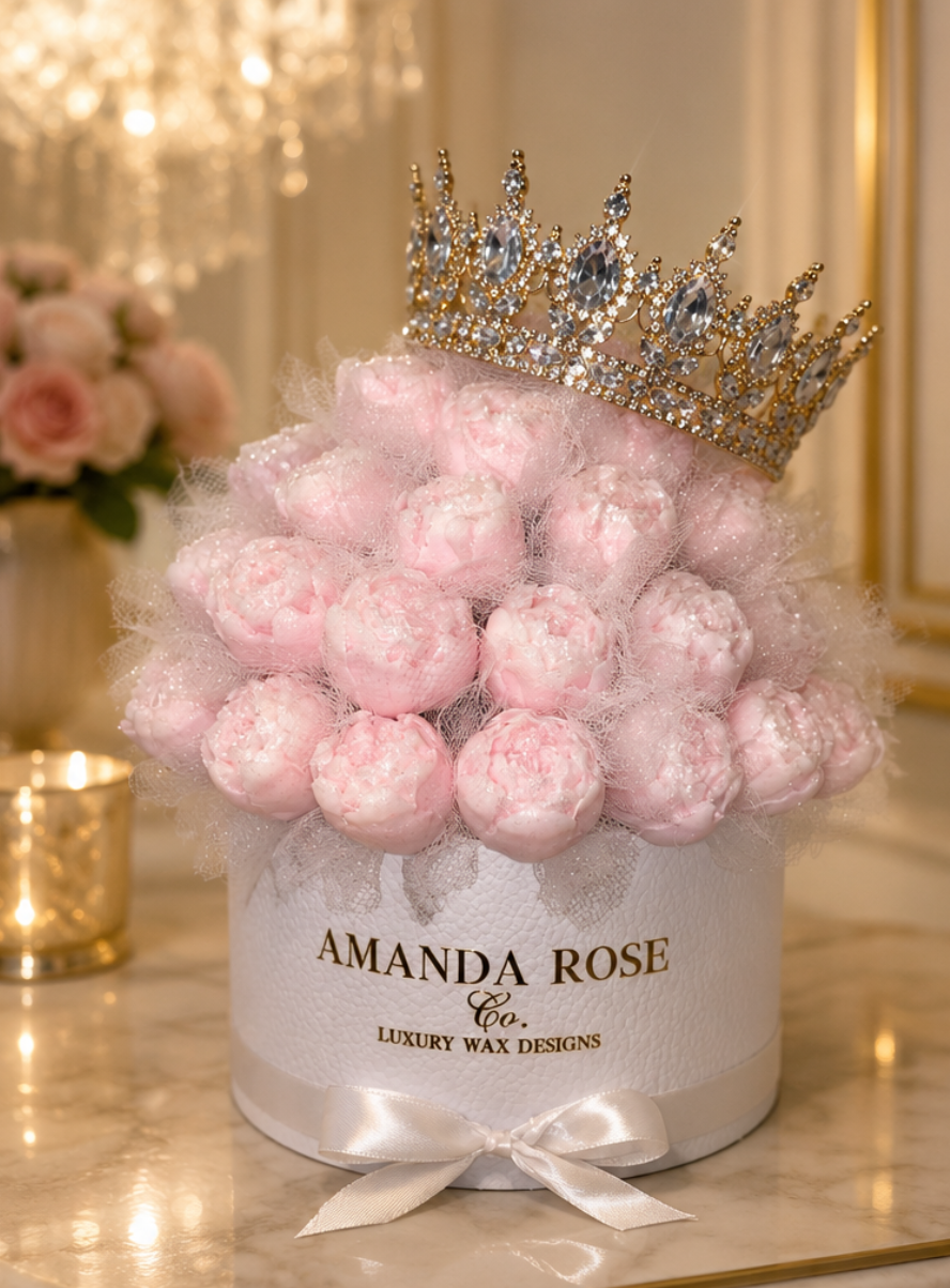 Decorative box filled with pink flowers and a crown, branded 'Amanda Rose Co.'