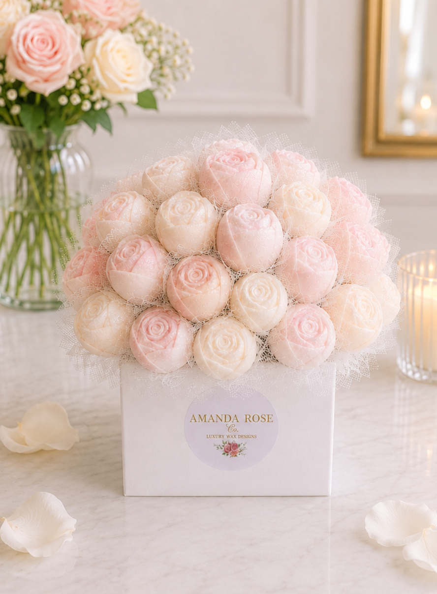Box of pink and white roses with 'Amanda Rose' branding on a light background
