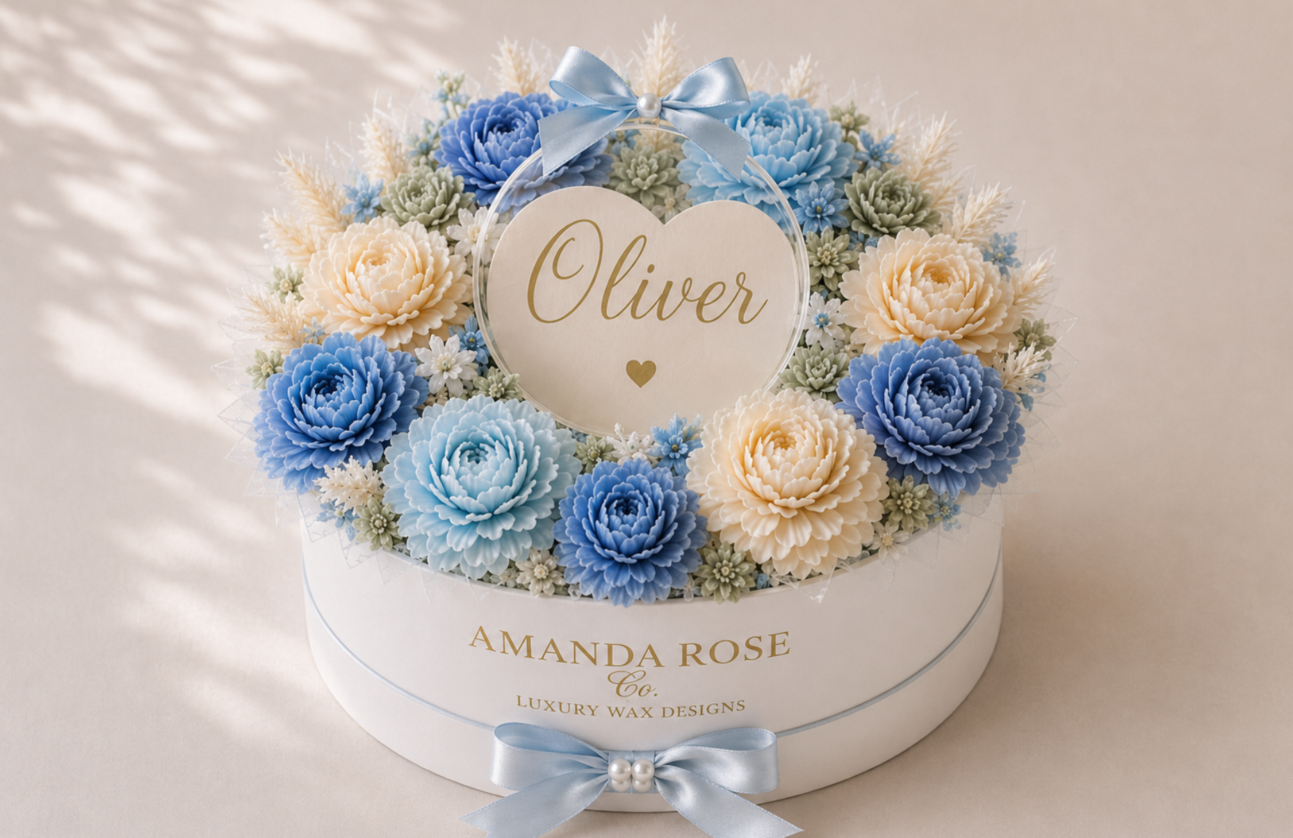 Floral arrangement in a box with 'Oliver' on a heart-shaped card, branded 'Amanda Rose Co'.