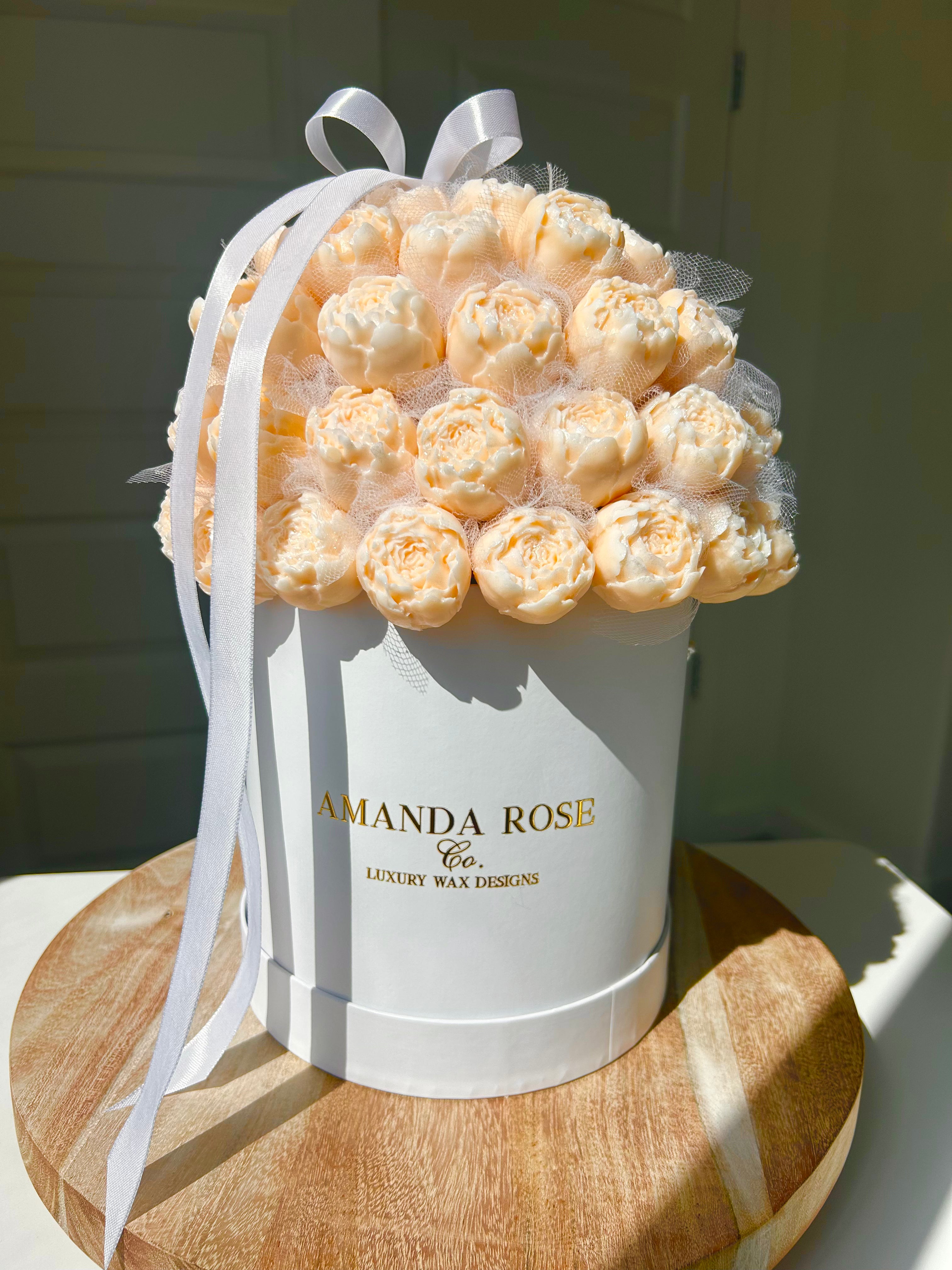 White box with peach-colored roses and a white ribbon, branded 'Amanda Rose Co'.